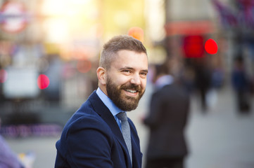 Obraz premium Hipster manager in the crowded street of London, Piccadilly Circus