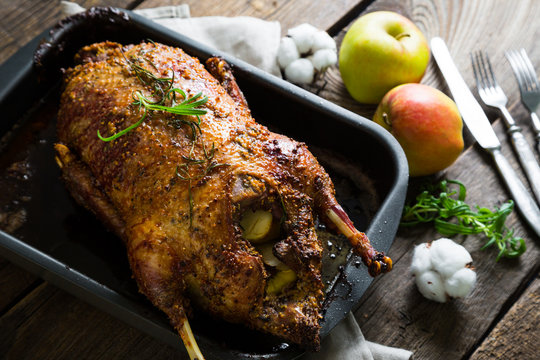 Roasted goose with apples in a rustic style