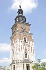 Fototapeta na wymiar Gothic city hall tower with clock in the Main Market Square of the Old City in Krakow in Poland