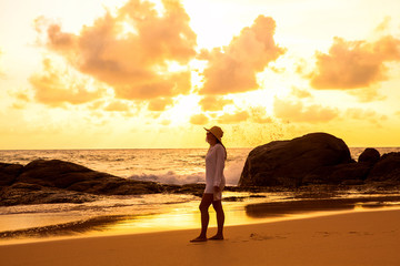 woman walking on the beach at sunset