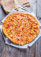 Delicious pizza with peppers, corn and peas