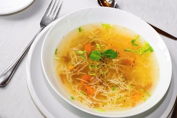 Beef soup with noodles in white plate