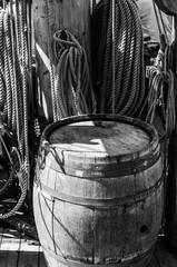 an old wooden barrel on the deck of a sailboat