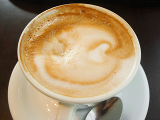 White Cup with a gourmet coffee and foam figure