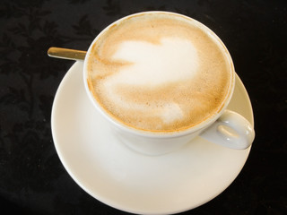 White Cup with a gourmet coffee and foam figure