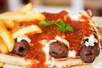 Fried kebab under yogurt sauce and tomato, Greece Athens, national food, traditional Greek cuisine