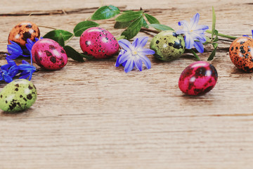 Easter egg with flowers on rustic wooden background