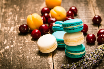 Fresh macaroons on wooden table ,vintage filter