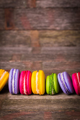 Fresh macaroons on wooden table ,vintage filter