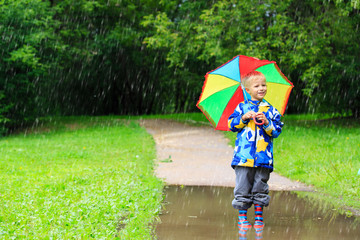 little boy with colorful umbrella outdoors