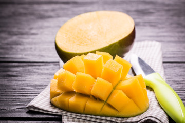 Fresh rip mango on a wooden background.Healthy food