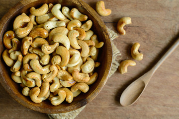 Fried cashew nuts with wooden spoon on sackcloth