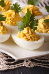 Stuffed eggs with mustard and parsley close-up. vertical
