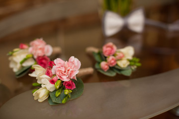 Elegant fresh flowers rose boutonniere on table closeup