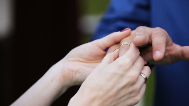 Bride putting wedding ring on groom during wedding ceremony.Wedding concept