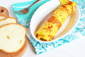 Rolls of omelette with cheese on a plate