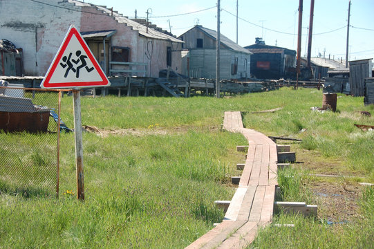 Children crossing warning road sign at rural area