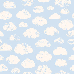 Seamless pattern with white clouds of different shapes on a blue background in flat style.Grange style