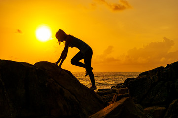 Girl walk along the cliffs by the sea at dawn