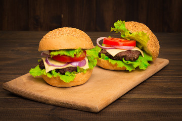 Gourmet Tasty Steak Burgers on a Wooden Tray. wooden background.