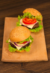 Gourmet Tasty Steak Burgers on a Wooden Tray. wooden background.