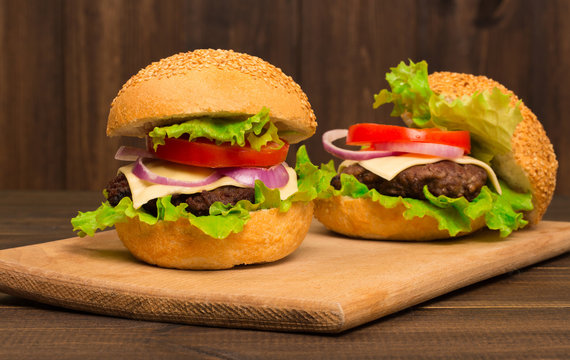 Gourmet Tasty Steak Burgers on a Wooden Tray. wooden background.