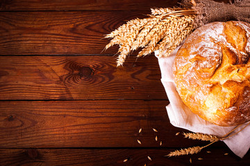 Homemade bread on wooden background. Country style. Food baking background