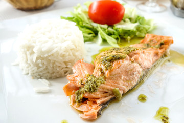 grilled salmon with sauce,lemon and tomato