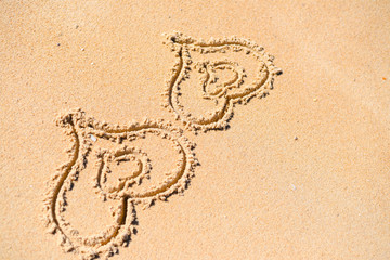 Double Love hearts impression on the sand background