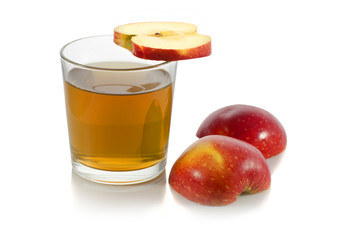 glass of apple juice with a slice of apple