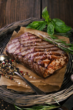 Grilled beef steak with spices, garlic and rosemary