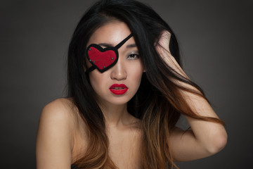 Woman with heart shape eye patch