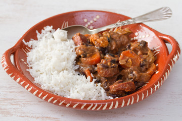 typical portuguese dish feijoada with rice in ceramic bowl