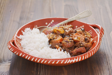 typical portuguese dish feijoada with rice in ceramic plate