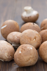 Fototapeta na wymiar mushrooms on brown wooden background