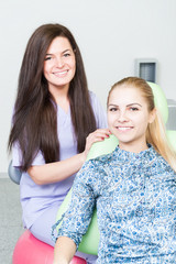 Beautiful dentist woman and cute female patient