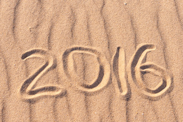 Numbers 2016 on beach - concept holiday background