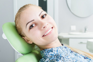 Female model smiling on dentist chair