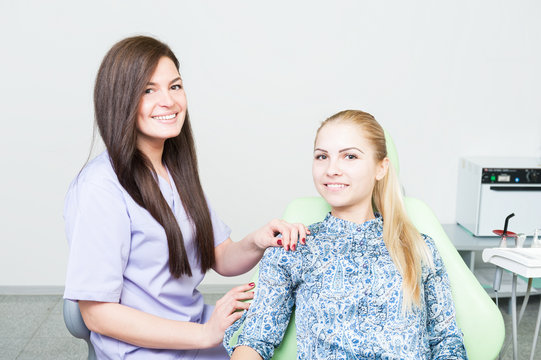 Friendly dentist woman and relaxed female patient