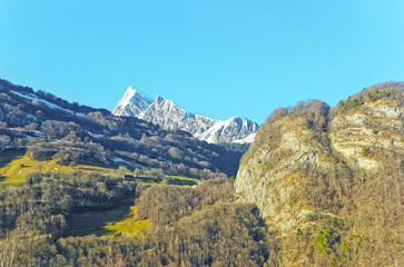 Road view to Swiss mountains and forest in winter