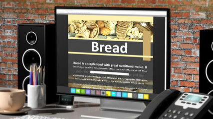 Monitor with Bread recipe on desktop with office objects.