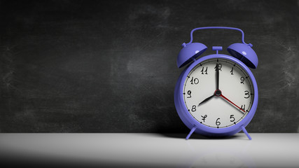 Retro blue alarm clock with blackboard and copy-space