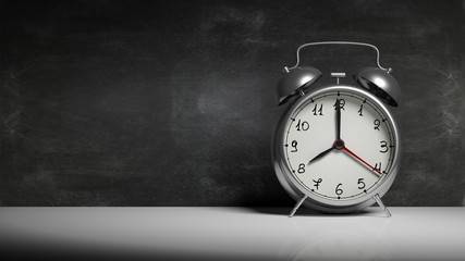 Retro silver alarm clock with blackboard and copy-space