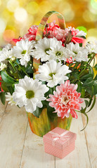 images of flowers and gift box on a wooden table closeup