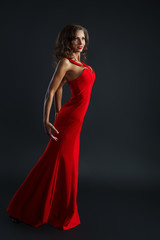Fototapeta premium Portrait of Beautiful Sensual Woman in Fashion Red Dress. 