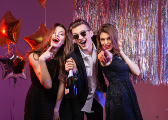 Group of excited joyful friends having party