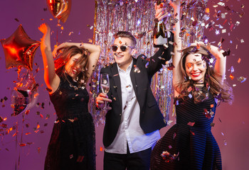 Excited cheerful young friends dancing and having party