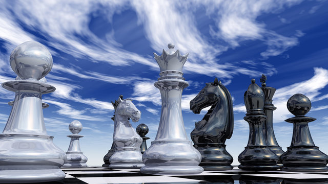 Шахматы, стоящие на доске на фоне облаков