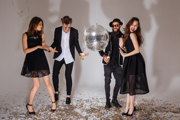 Multiethnic group of attractive joyful young people dancing together