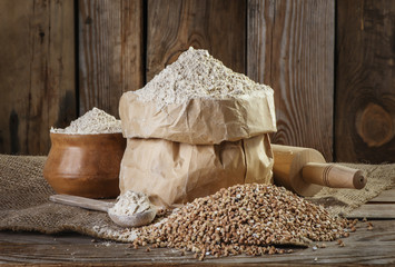 buckwheat flour  on the old wooden background closeup